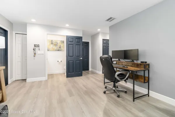 a view of workspace with wooden floor and windows