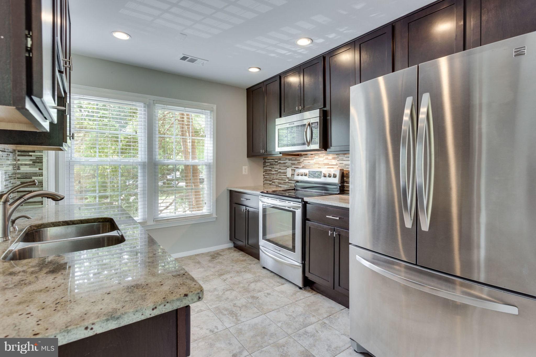 7764 Euclid Way Springfield, VA 22153 - Photo 5 of 18 Granite, Tile Backsplash, Stainless Steel