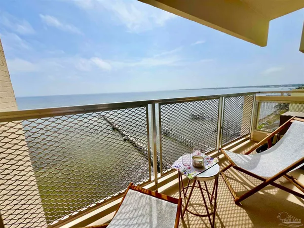 a view of balcony with chairs and wooden floor