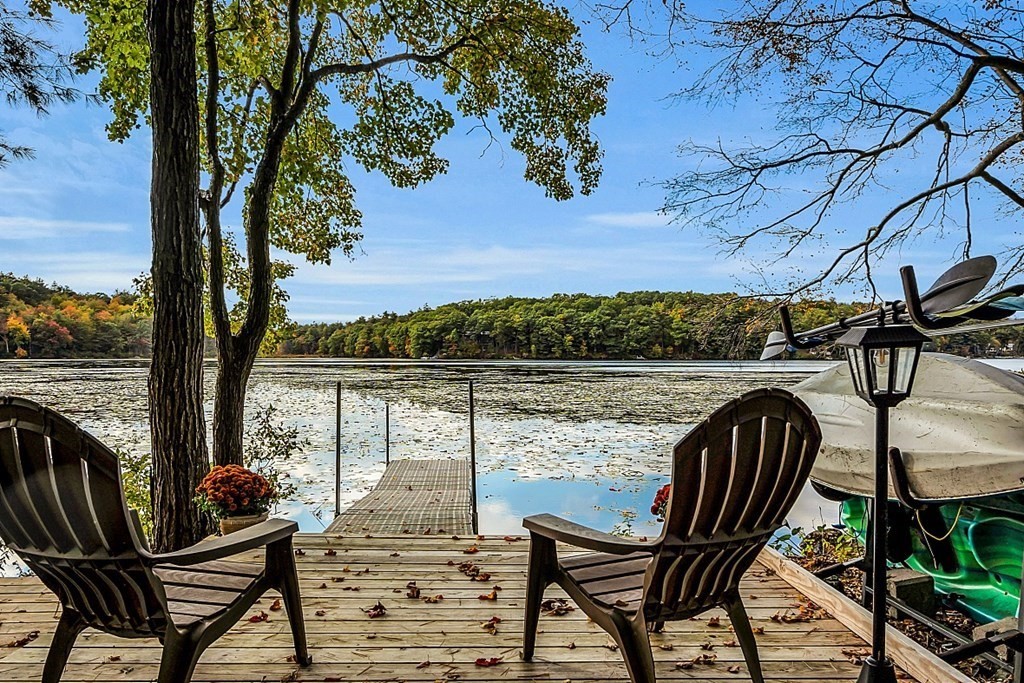 a view of balcony with wooden floor and outdoor seating