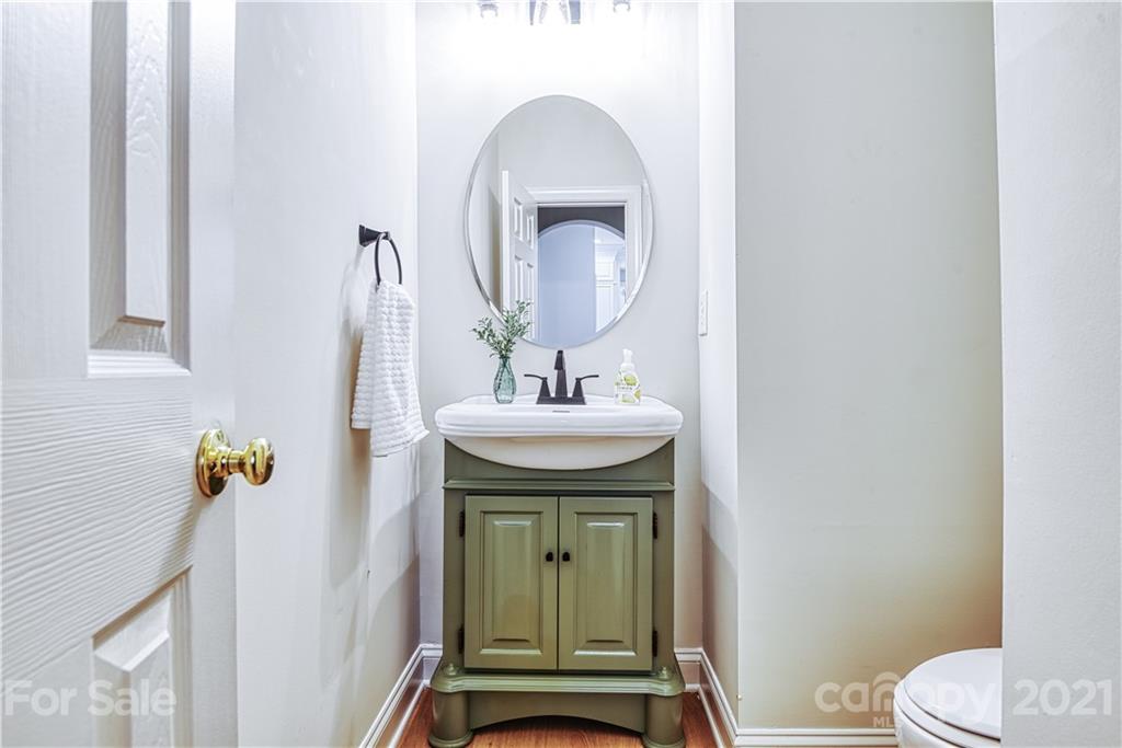 1380 Barnett Woods Fort Mill, SC 29708 - Photo 17 of 31 a bathroom with a sink a mirror and a toilet