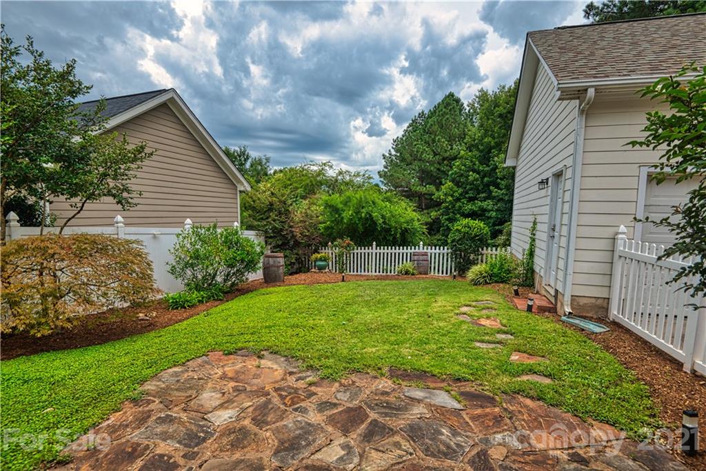 1380 Barnett Woods Fort Mill, SC 29708 - Photo 31 of 31 a view of a backyard with potted plants and a large tree