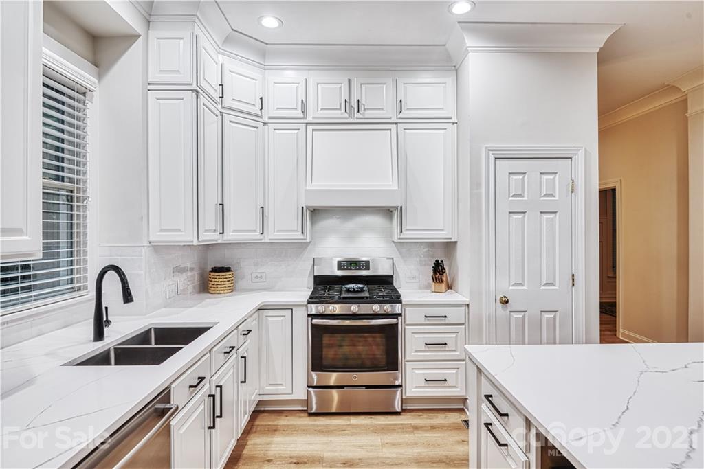 1380 Barnett Woods Fort Mill, SC 29708 - Photo 9 of 31 a kitchen with white cabinets and appliances