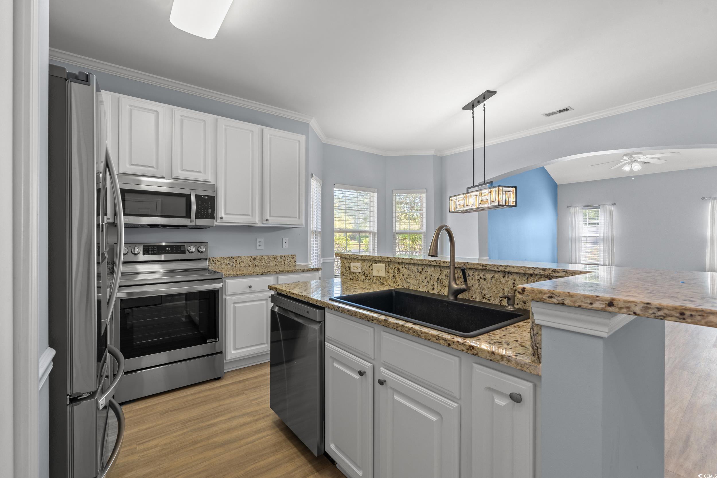 718 Botany Loop, Unit 718 Murrells Inlet, SC 29576 - Photo 3 of 40 Kitchen with white cabinets, a sink, ceiling fan,