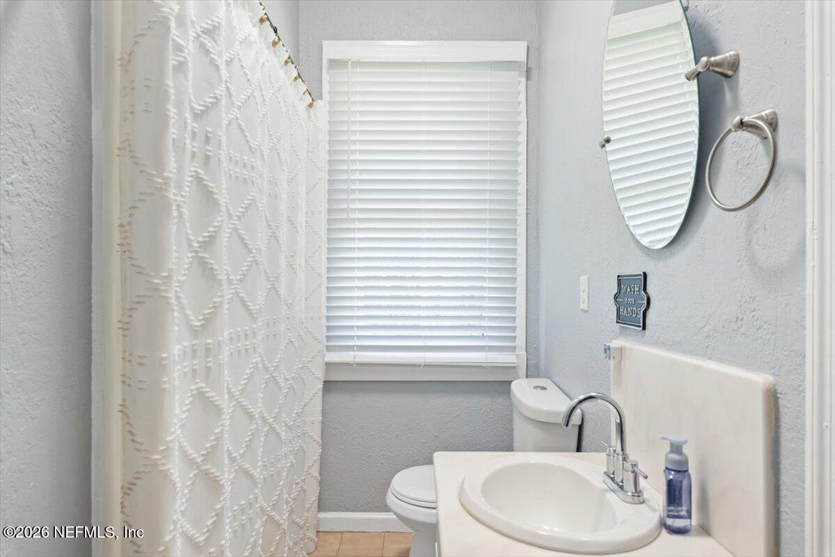 45116 Kilpatrick Road Callahan, FL 32011 - Photo 21 of 41 a bathroom with a sink a toilet and a mirror