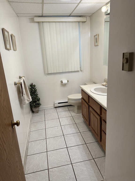 124 Beech Street Boston, MA 02131 - Photo 3 of 8 a bathroom with a sink a toilet and mirror