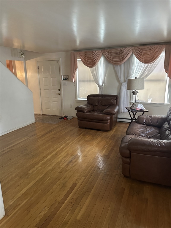 124 Beech Street Boston, MA 02131 - Photo 8 of 8 a living room with furniture and a flat screen tv