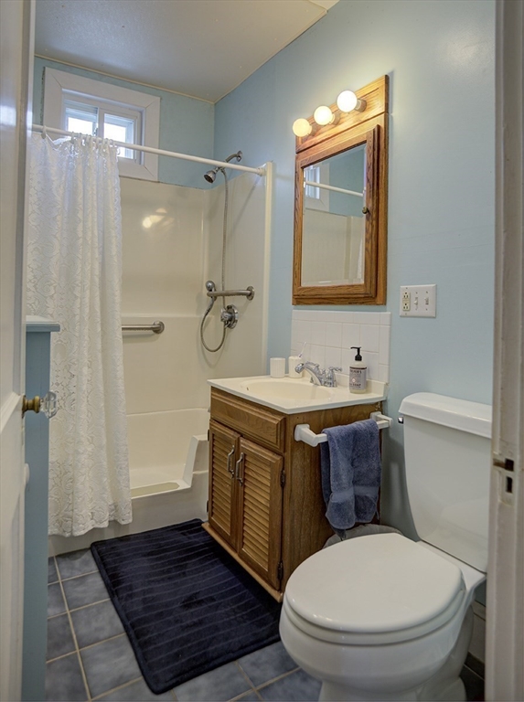 44 Cottage Park Road Winthrop, MA 02152 - Photo 14 of 39 a bathroom with a granite countertop sink toilet and shower