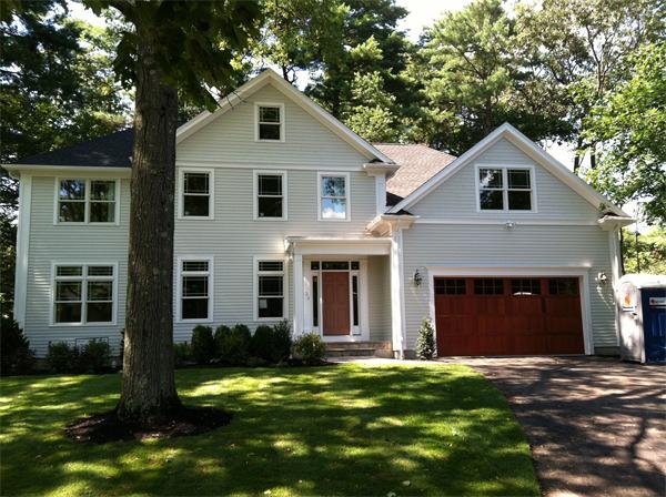 27 Leewood Road Wellesley, MA 02482 - Photo 1 of 17 a front view of a house with a yard and garage
