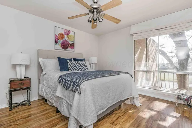 a bed sitting in a bedroom next to a window