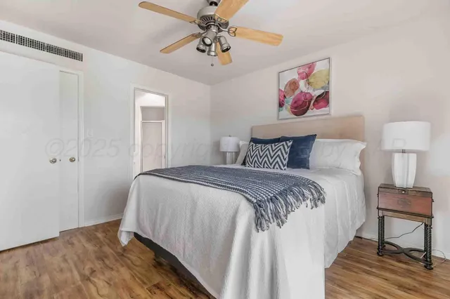 a bedroom with a bed and painting on the wall