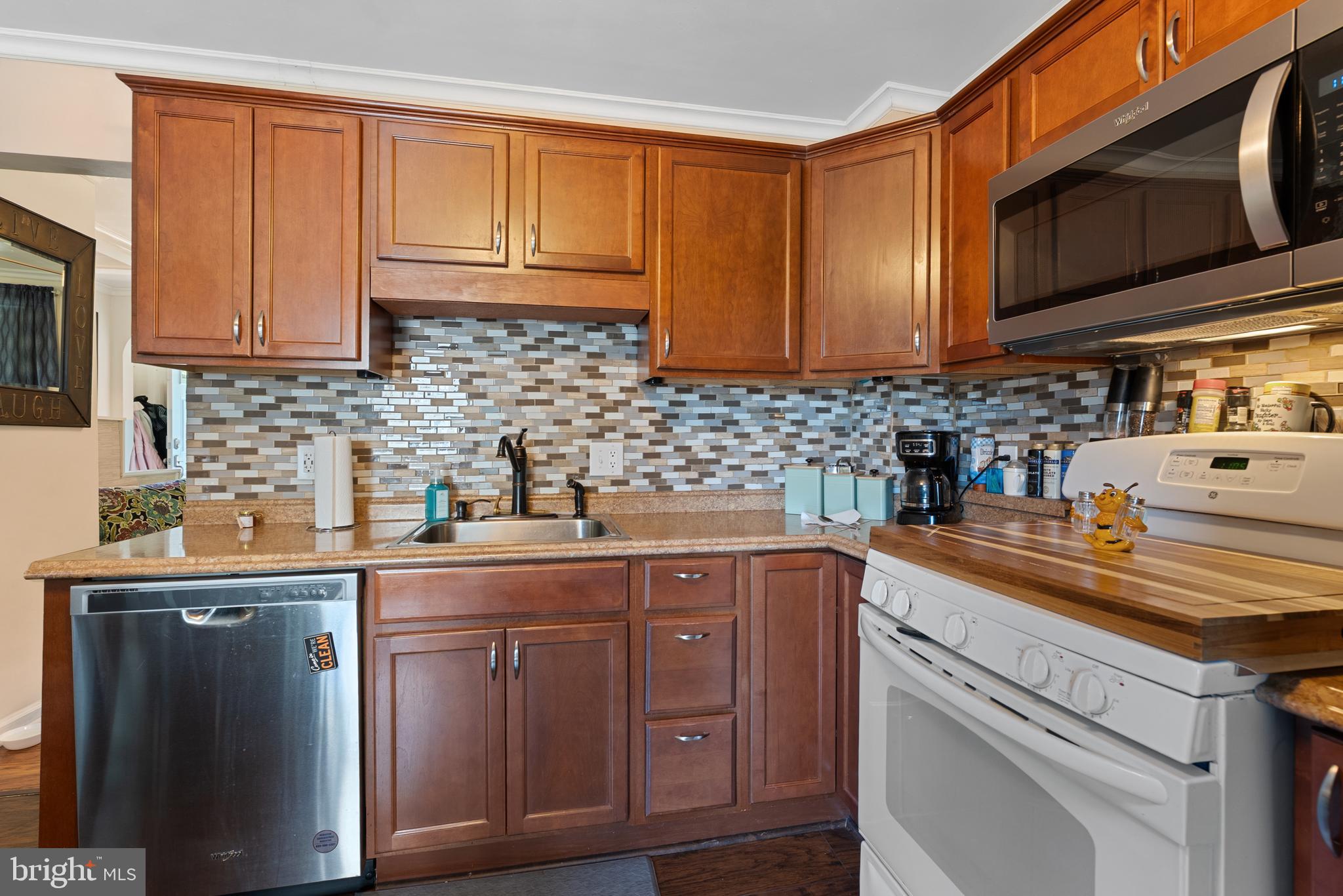 70 Del Rio Road Baltimore, MD 21222 - Photo 8 of 40 a kitchen with stainless steel appliances granite countertop a sink a stove and cabinets