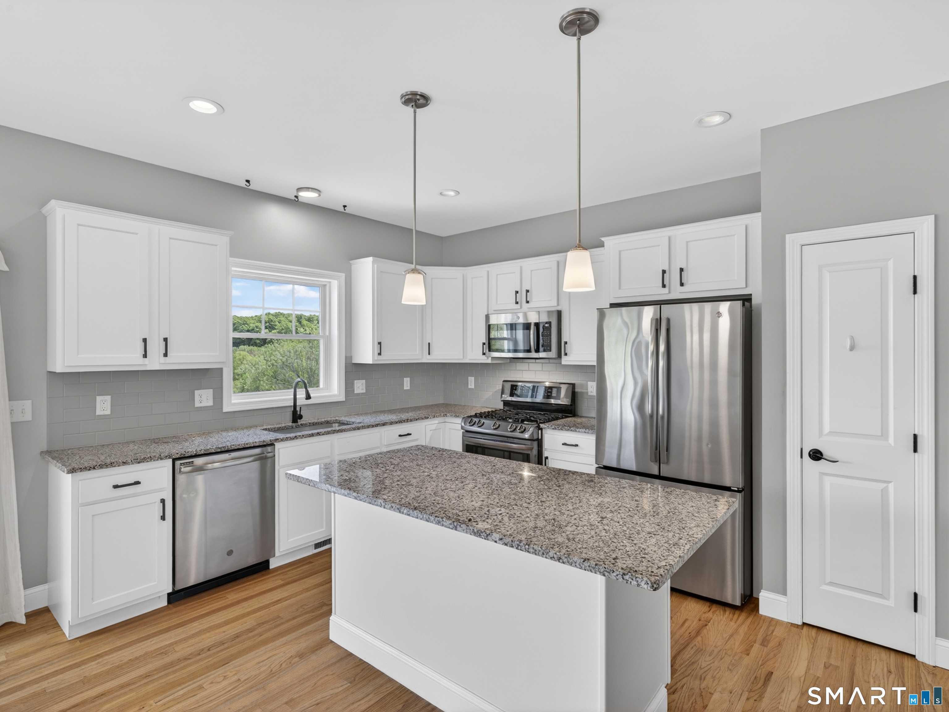 650 Ridgewood Road Middletown, CT 06457 - Photo 14 of 40 a kitchen with stainless steel appliances granite countertop a sink refrigerator and cabinets