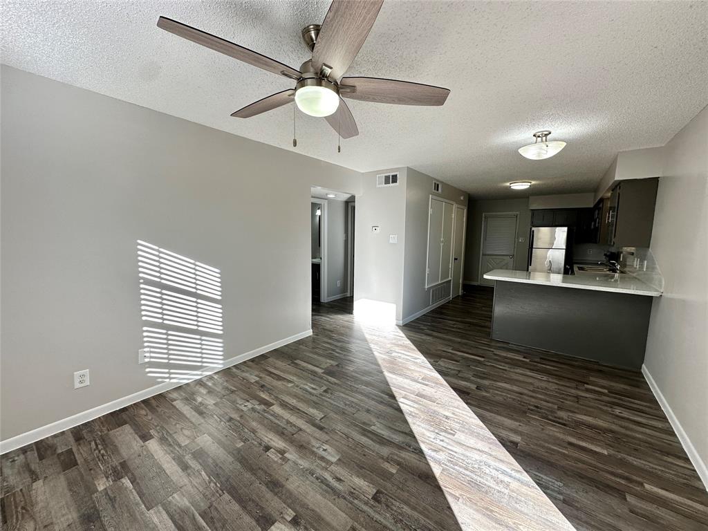2006 Jane Street, Unit F Longview, TX 75601 - Photo 2 of 9 a view of a hallway with wooden floor and ceiling fan