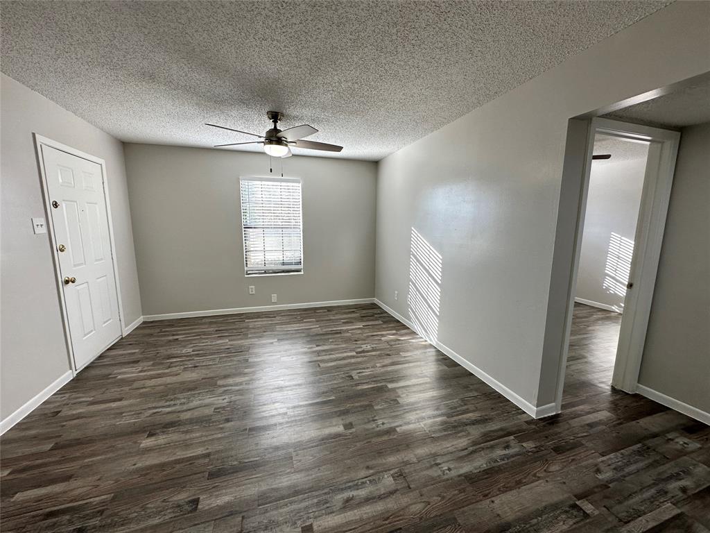 2006 Jane Street, Unit F Longview, TX 75601 - Photo 3 of 9 an empty room with wooden floor and windows