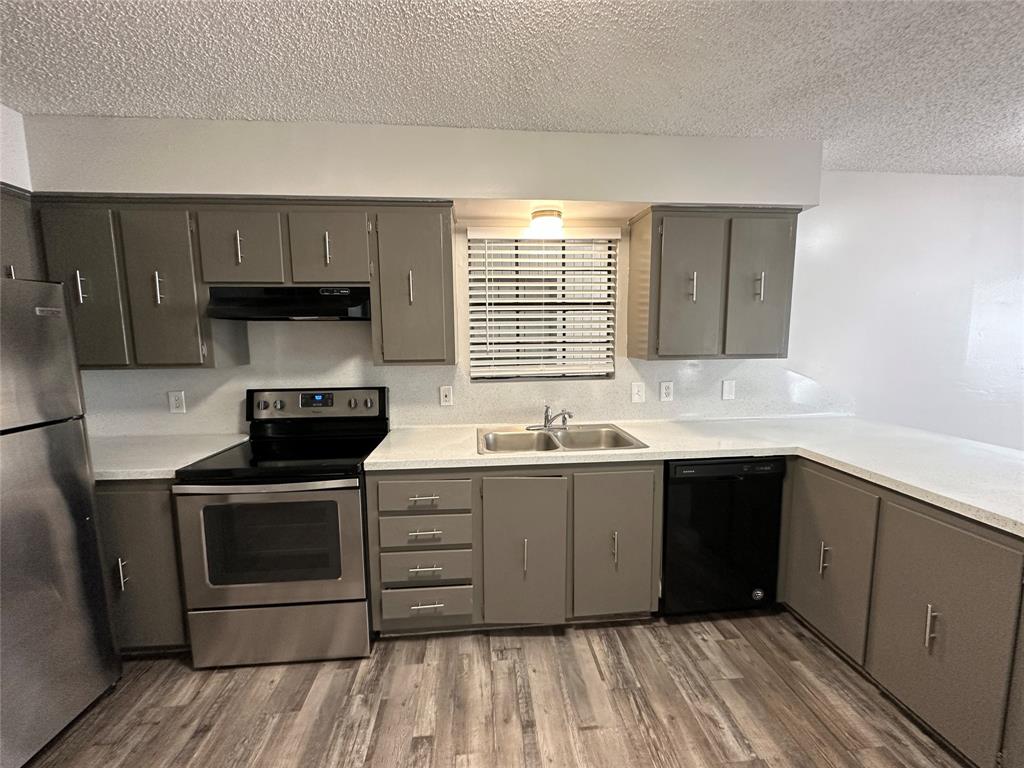 2006 Jane Street, Unit F Longview, TX 75601 - Photo 4 of 9 a kitchen with a sink stove and cabinets