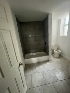 a bathroom with a bathtub and toilet