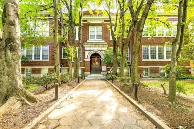 a view of a house with swimming pool and sitting area