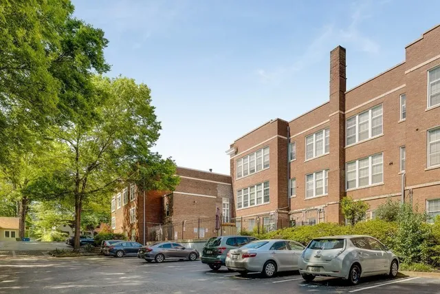 a bathroom with a sink a potted plant and a view of living room