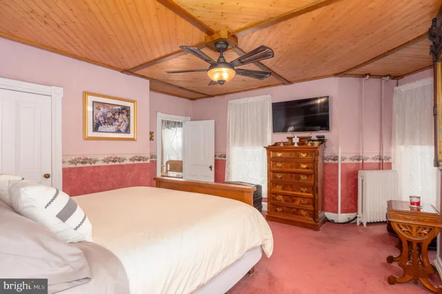 a bedroom with furniture and a chair