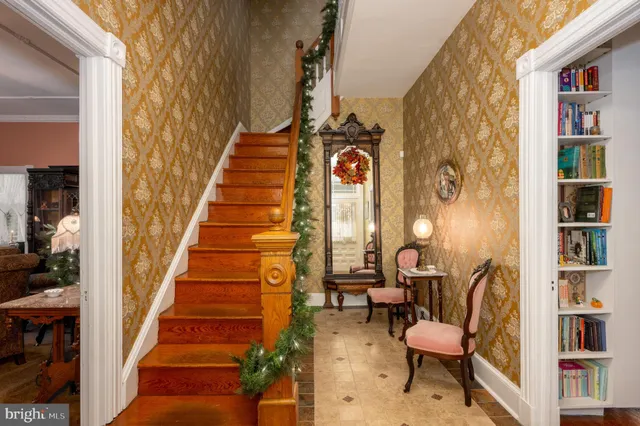 a view of a dining room with furniture and chandelier