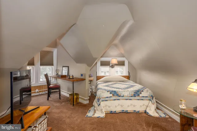 a view of a dining room with furniture and a window