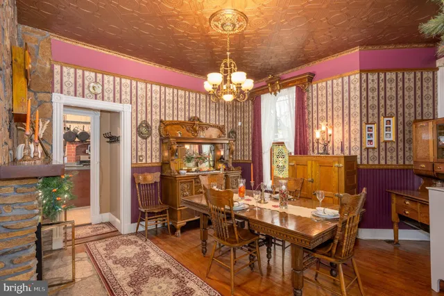 a living room with patio furniture and a chandelier