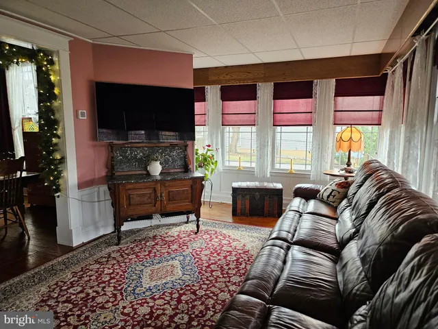 a bedroom with furniture and a large window