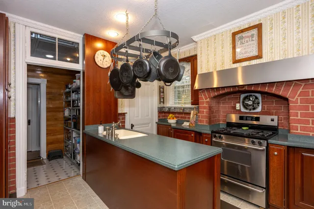 a living room with furniture a chandelier and a large window