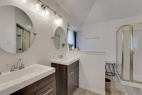 a bathroom with a sink vanity and a mirror