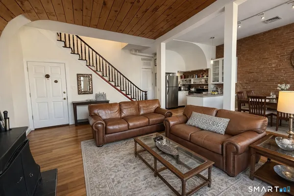 a living room with furniture and wooden floor