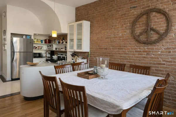 a dining room with furniture and wooden floor