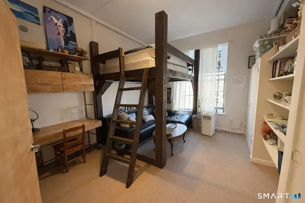 a view of a room with lots of stuff and furniture