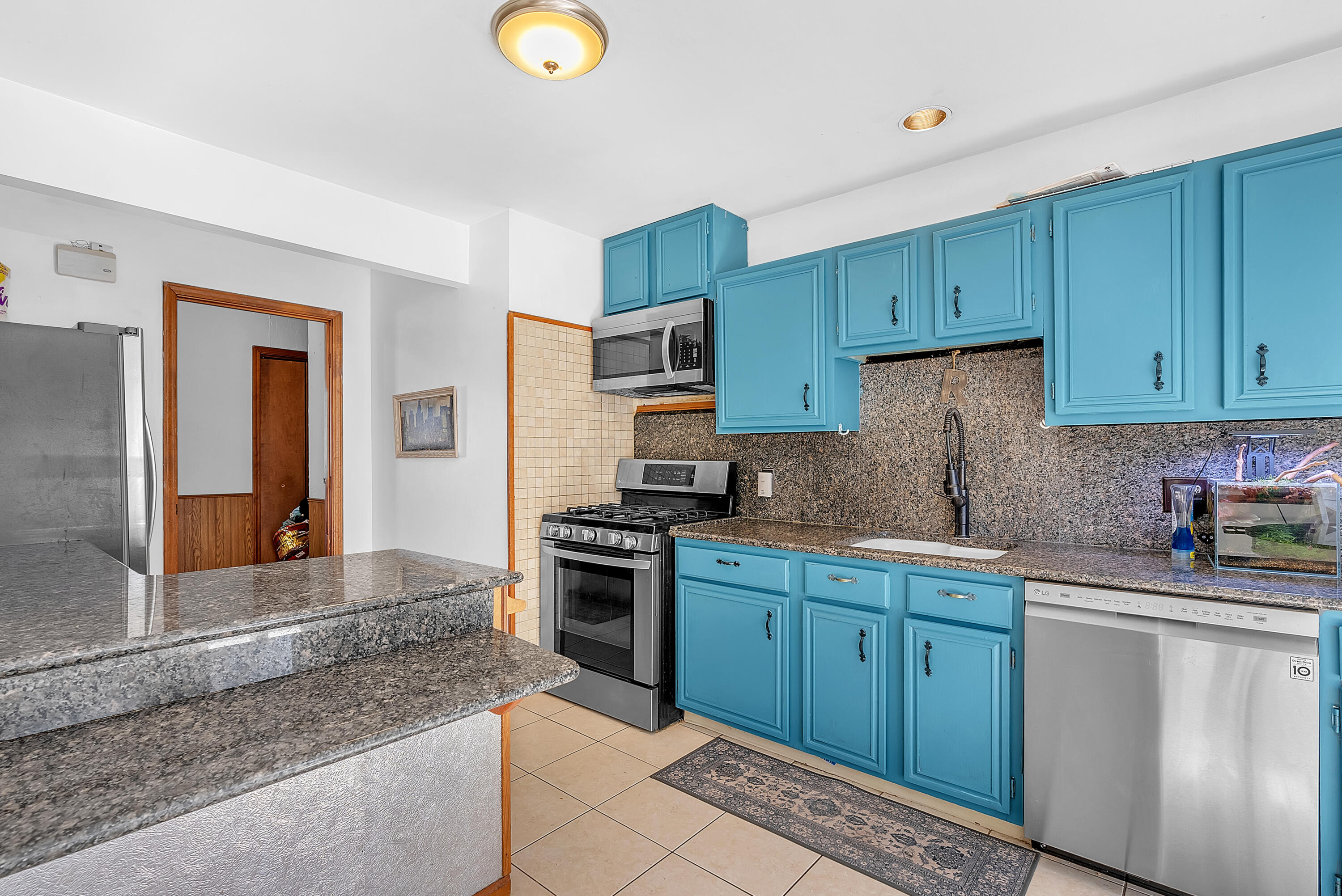 5351 East Honor Avenue Demotte, IN 46310 - Photo 12 of 31 a kitchen with stainless steel appliances granite countertop a sink stove and cabinets