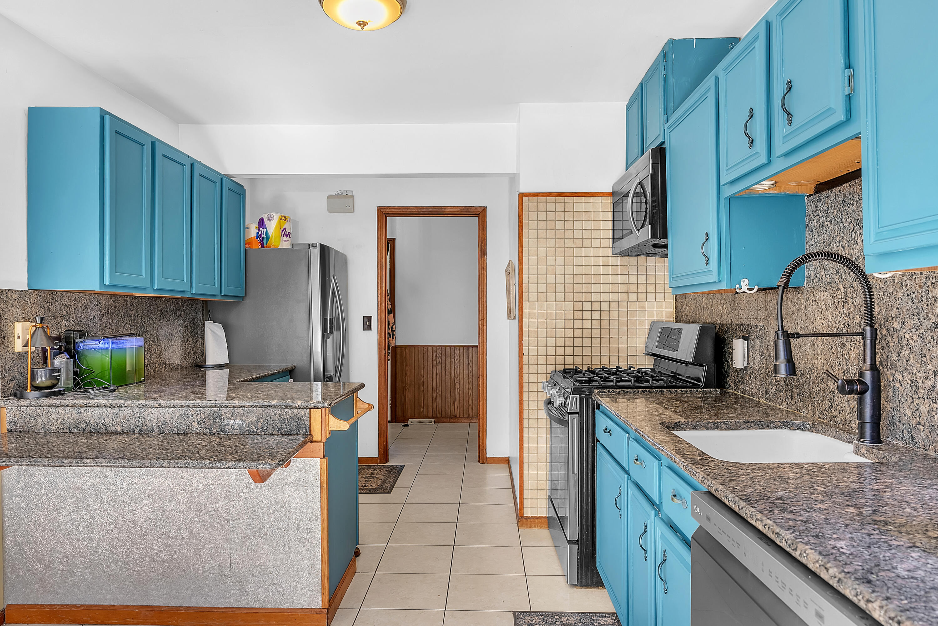 5351 East Honor Avenue Demotte, IN 46310 - Photo 13 of 31 a kitchen with stainless steel appliances granite countertop a sink and cabinets