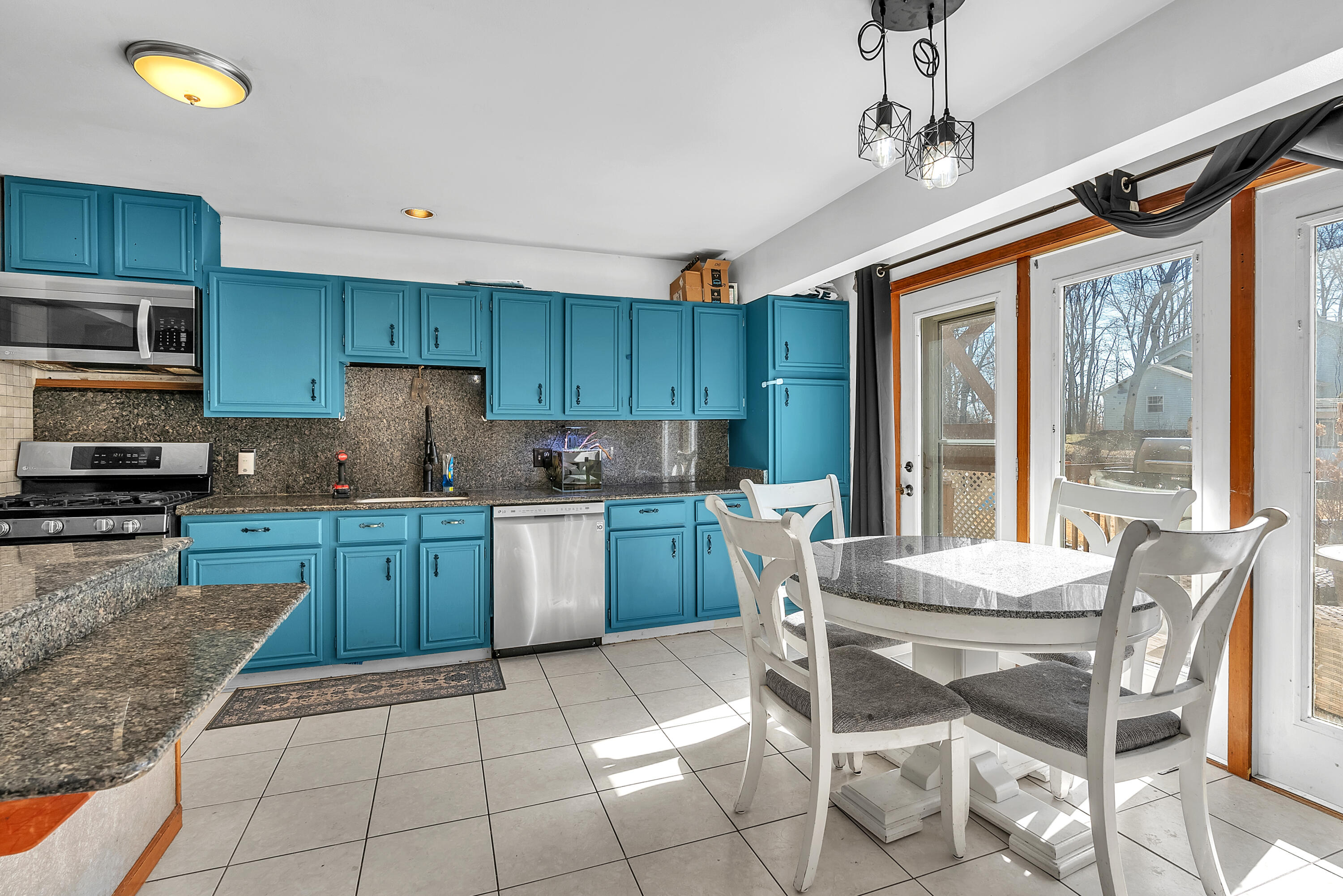 5351 East Honor Avenue Demotte, IN 46310 - Photo 9 of 31 a kitchen with a stove a sink a refrigerator and a microwave