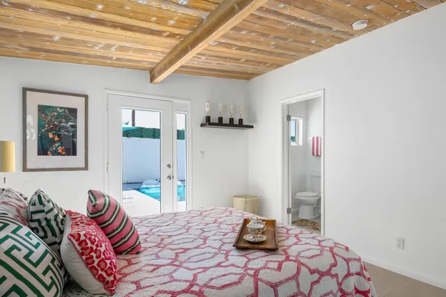 a room with pool table and windows