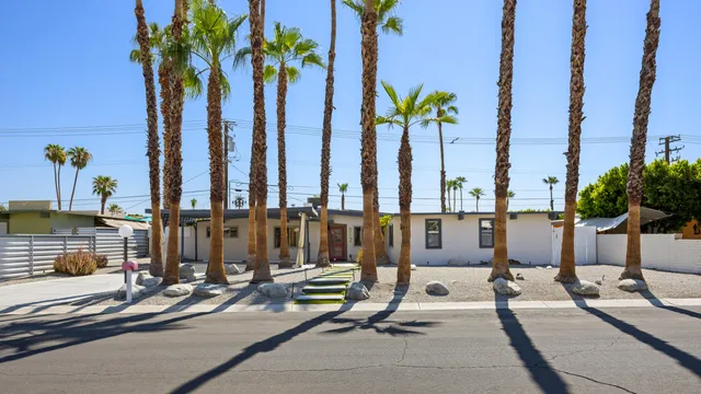 a front view of a house with swimming pool outdoor seating and yard