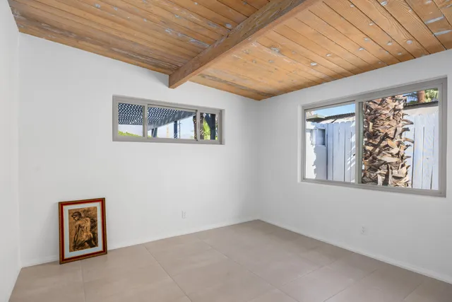 a view of a patio with chairs and umbrellas