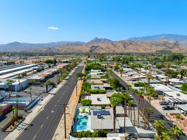 a view of a swimming pool with a patio and a yard