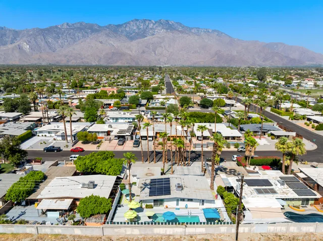 a view of a swimming pool with outdoor seating