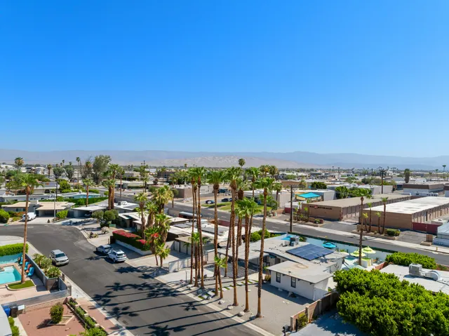 a front view of a house with wooden floor and windows