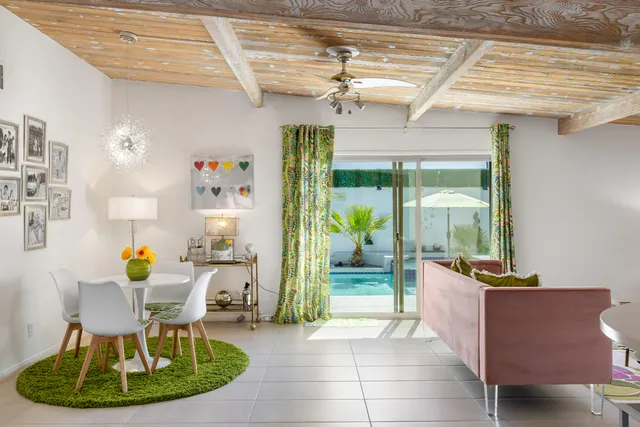 a bedroom with furniture a rug and a window