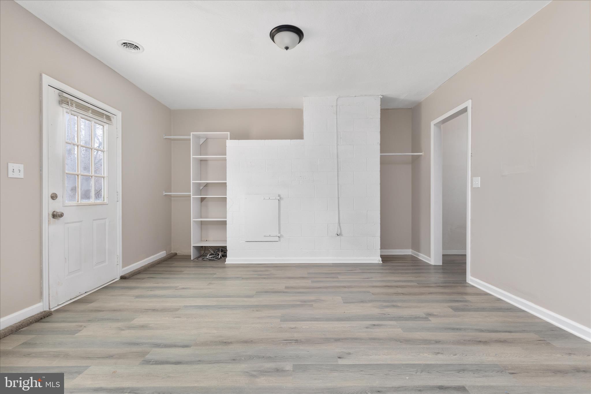 503 Pomeroy Road Front Royal, VA 22630 - Photo 23 of 41 an empty room with wooden floor and windows