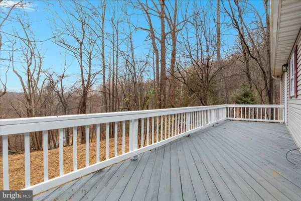 a view of balcony with wooden floor and fence