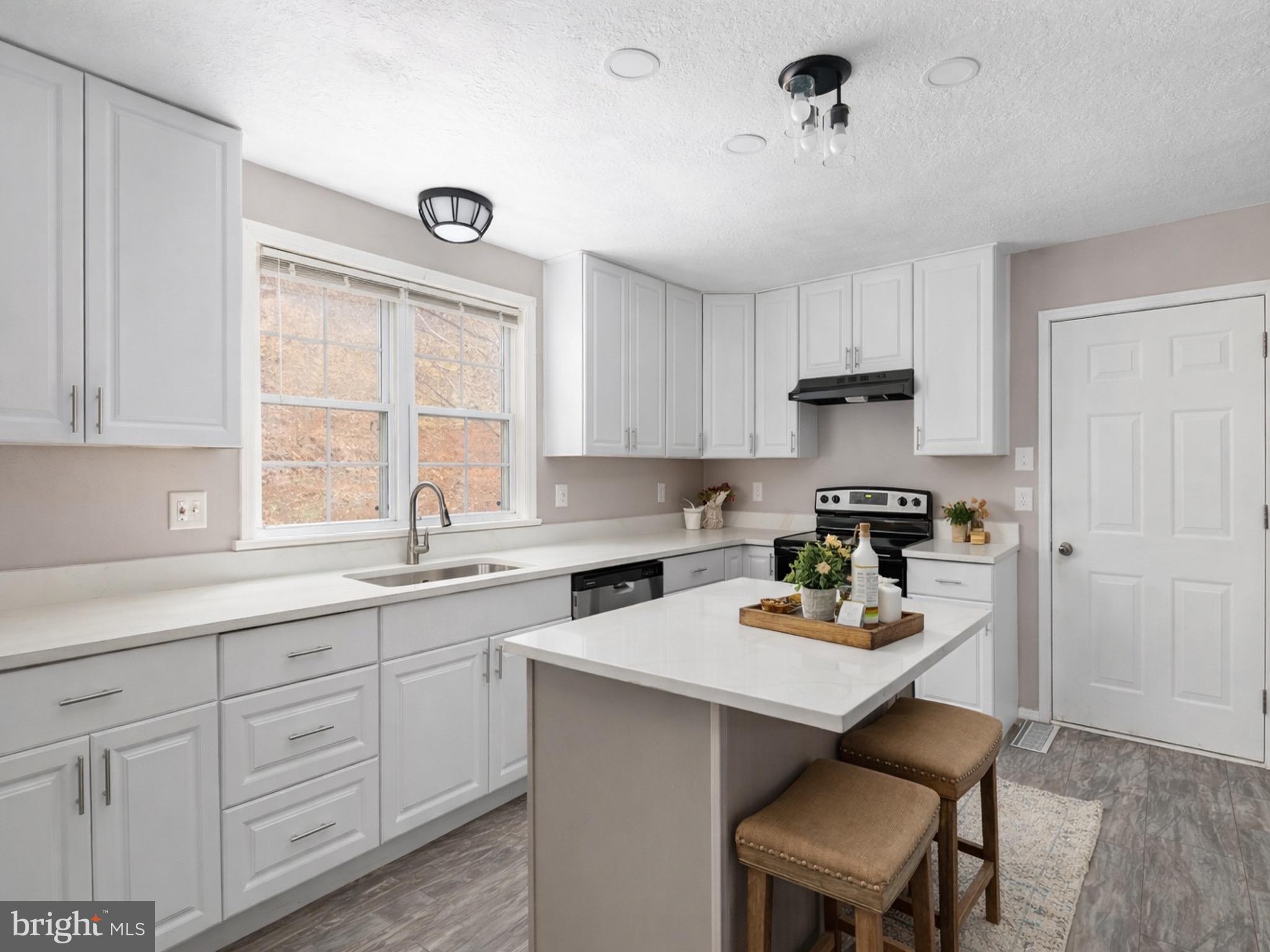 503 Pomeroy Road Front Royal, VA 22630 - Photo 10 of 41 a kitchen with a sink stove and cabinets