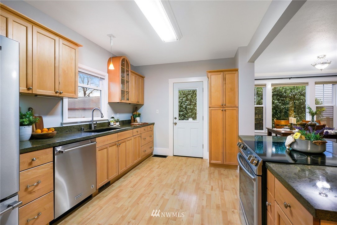 1509 Rucker Avenue Everett, WA 98201 - Photo 11 of 39 a kitchen with stainless steel appliances granite countertop a stove a sink and a refrigerator