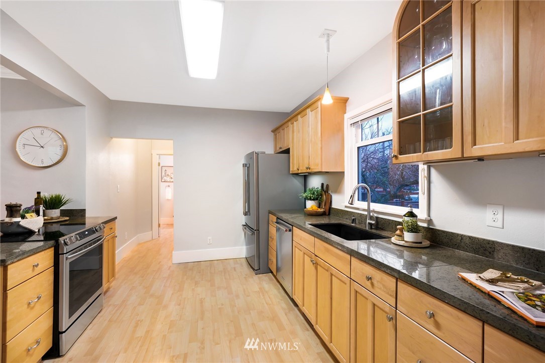 1509 Rucker Avenue Everett, WA 98201 - Photo 12 of 39 a kitchen with stainless steel appliances a sink stove and refrigerator