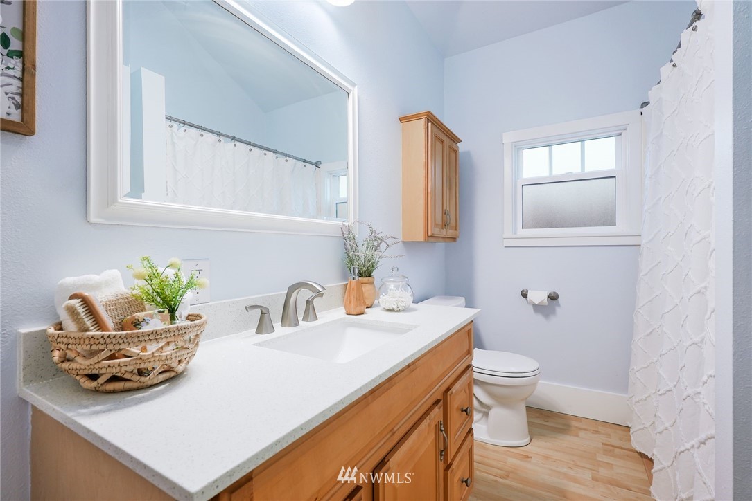 1509 Rucker Avenue Everett, WA 98201 - Photo 14 of 39 a bathroom with a sink a toilet and mirror