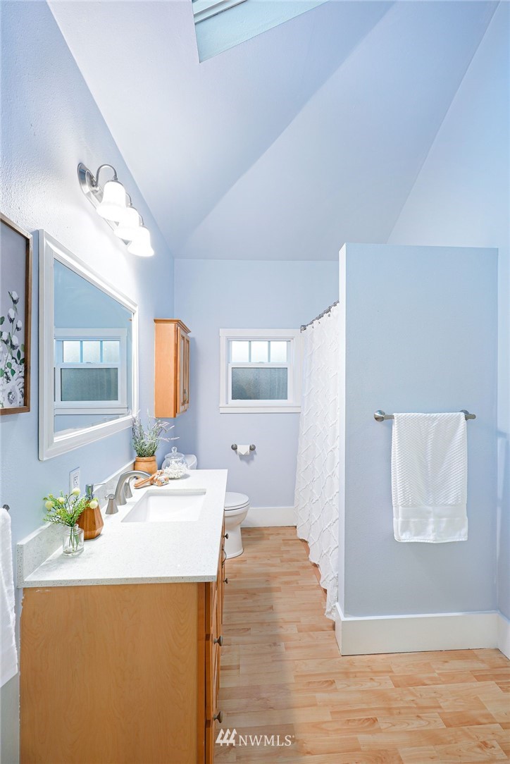 1509 Rucker Avenue Everett, WA 98201 - Photo 15 of 39 a room with a sink dishwasher and a dining table with wooden floor